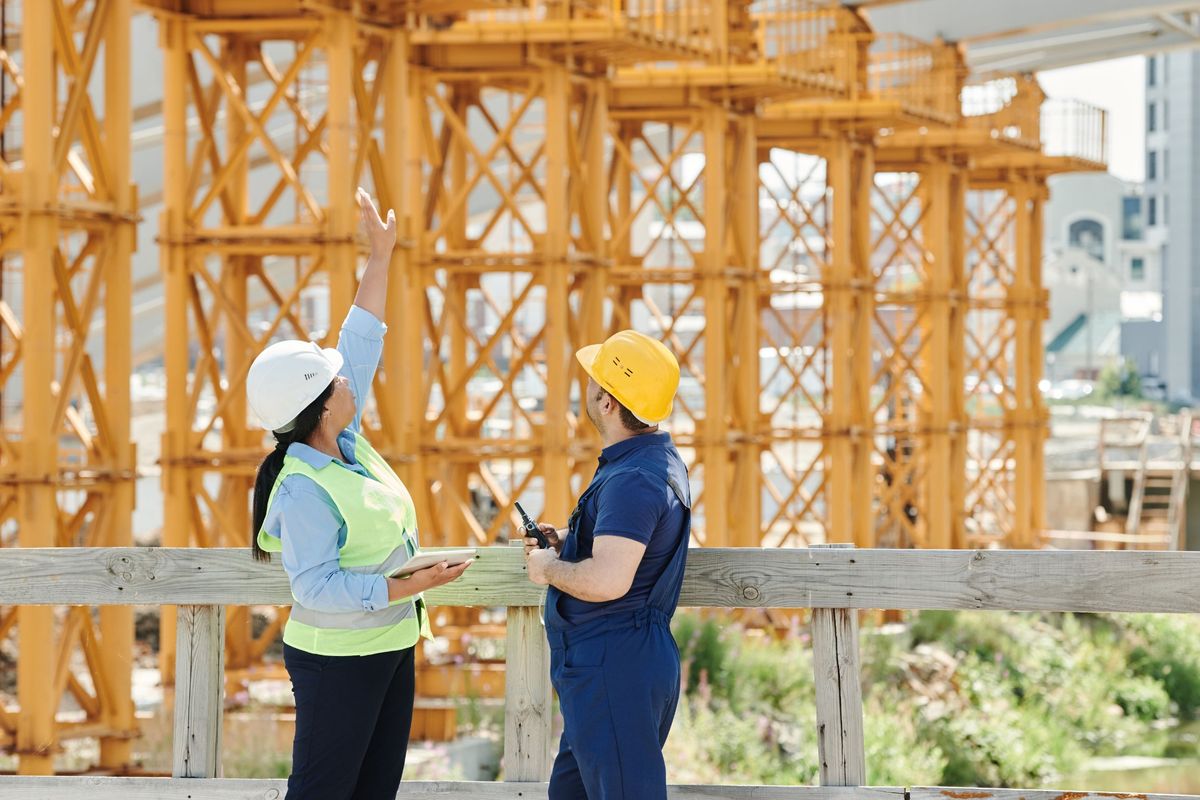 Inspector and site worker reviewing a structure on a construction site