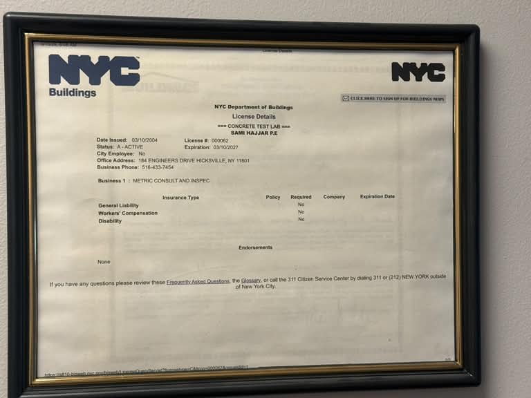 NYC Department of Buildings concrete testing laboratory license #000062, framed in the Metric office
