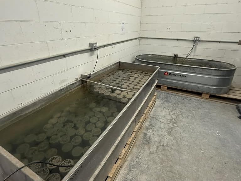 Concrete cylinders curing in a water tank in the Metric laboratory