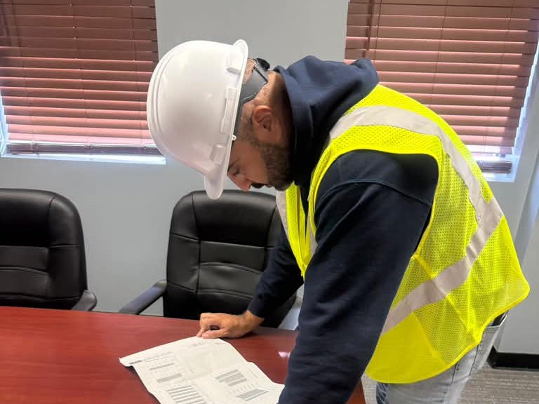 Metric engineer reviewing structural drawings at the office
