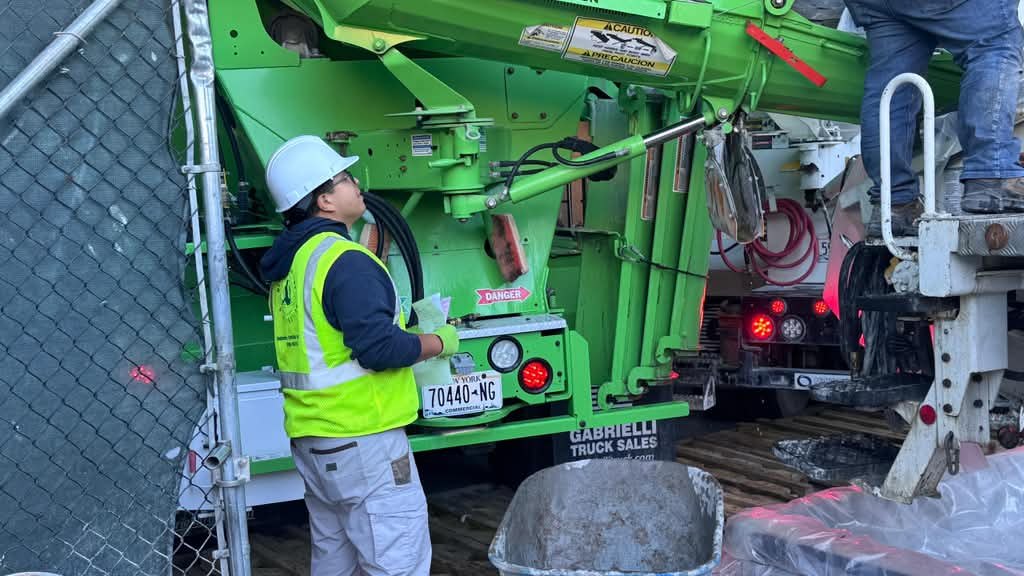 Metric technician checking the delivery ticket at a ready-mix concrete truck